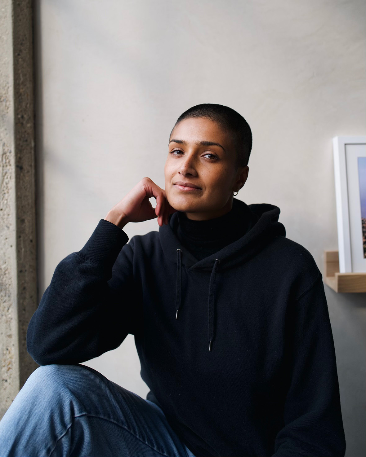 Chloe Abrahams, a Sri Lankan-British filmmaker with a shaved head and black hoodie.
