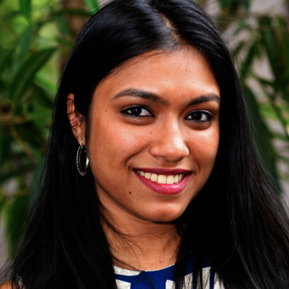 Bedatri D. Choudhury is an Indian woman with long hair, wearing hoop earrings.