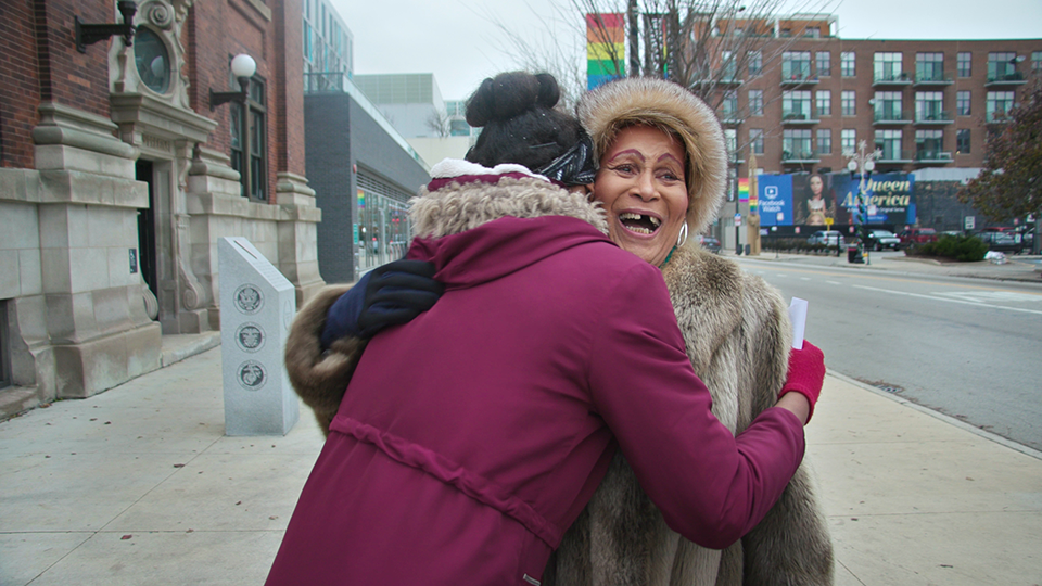 Mama Gloria hugs a young trans woman