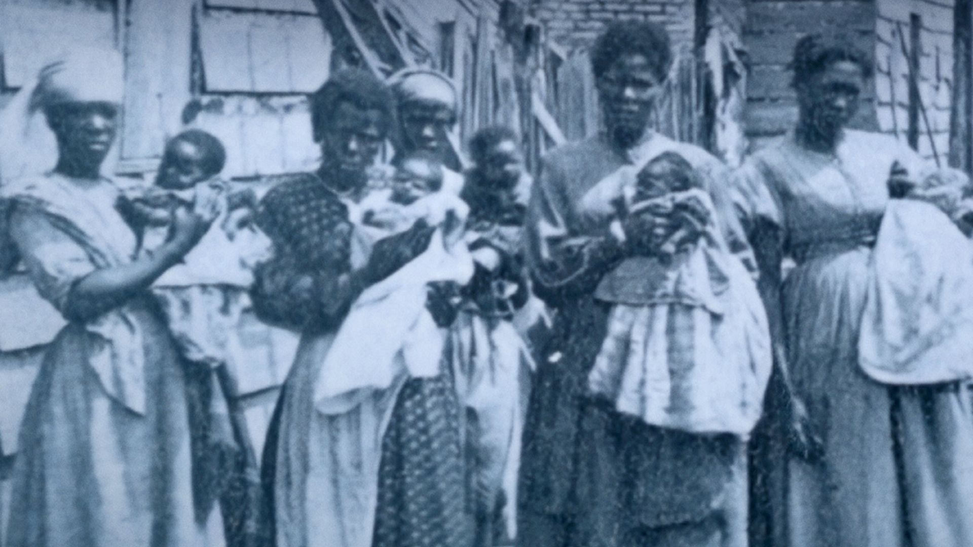 A group of five enslaved women in the American South each hold newborn babies.